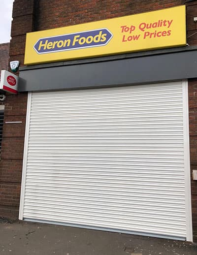 Shutters installed on Heron Foods shop front by DT Services