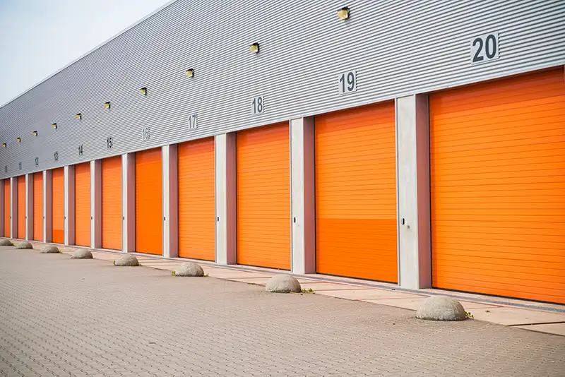A warehouse, with red roller shutter doors closed