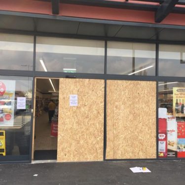 A damaged shop front in Hull, boarded and secured by DT Services